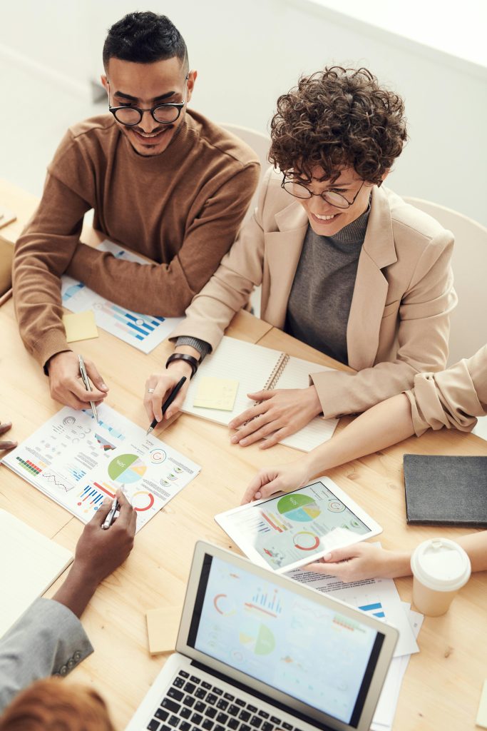 Top-down shot of two people at a table in a meeting