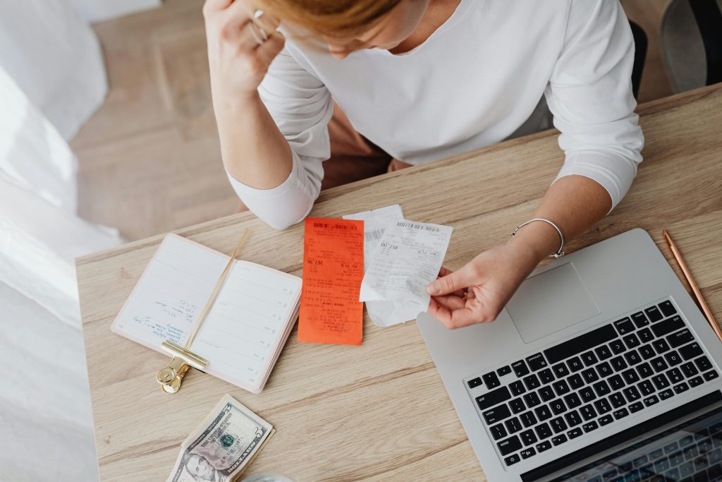 Top-down video of a woman handling finances at her desk